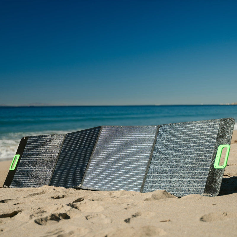 Nature's Generator 200W Folding Solar Panel - Scene - Foldable solar panel on a sandy beach with ocean and clear sky in the background 7